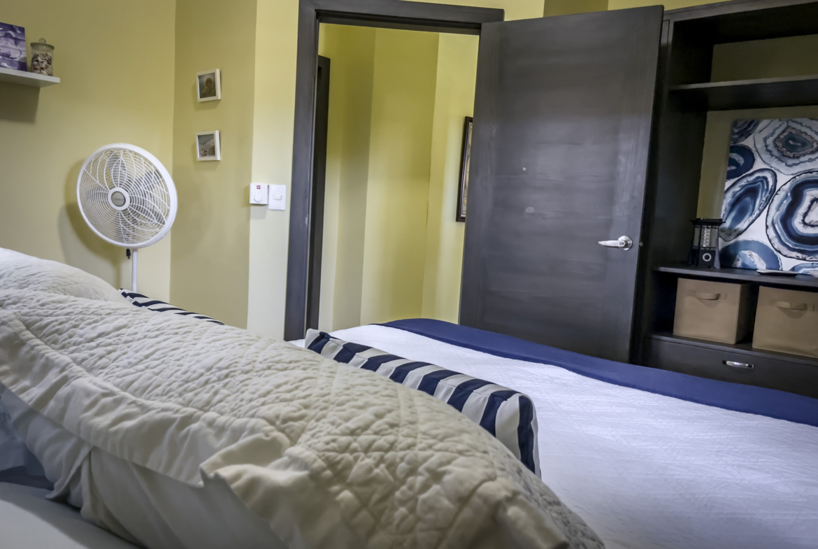 buyDRproperty Bedroom interior of a stunning 2 bedroom villa with bed, fan, and closet. Sosua Real Estate