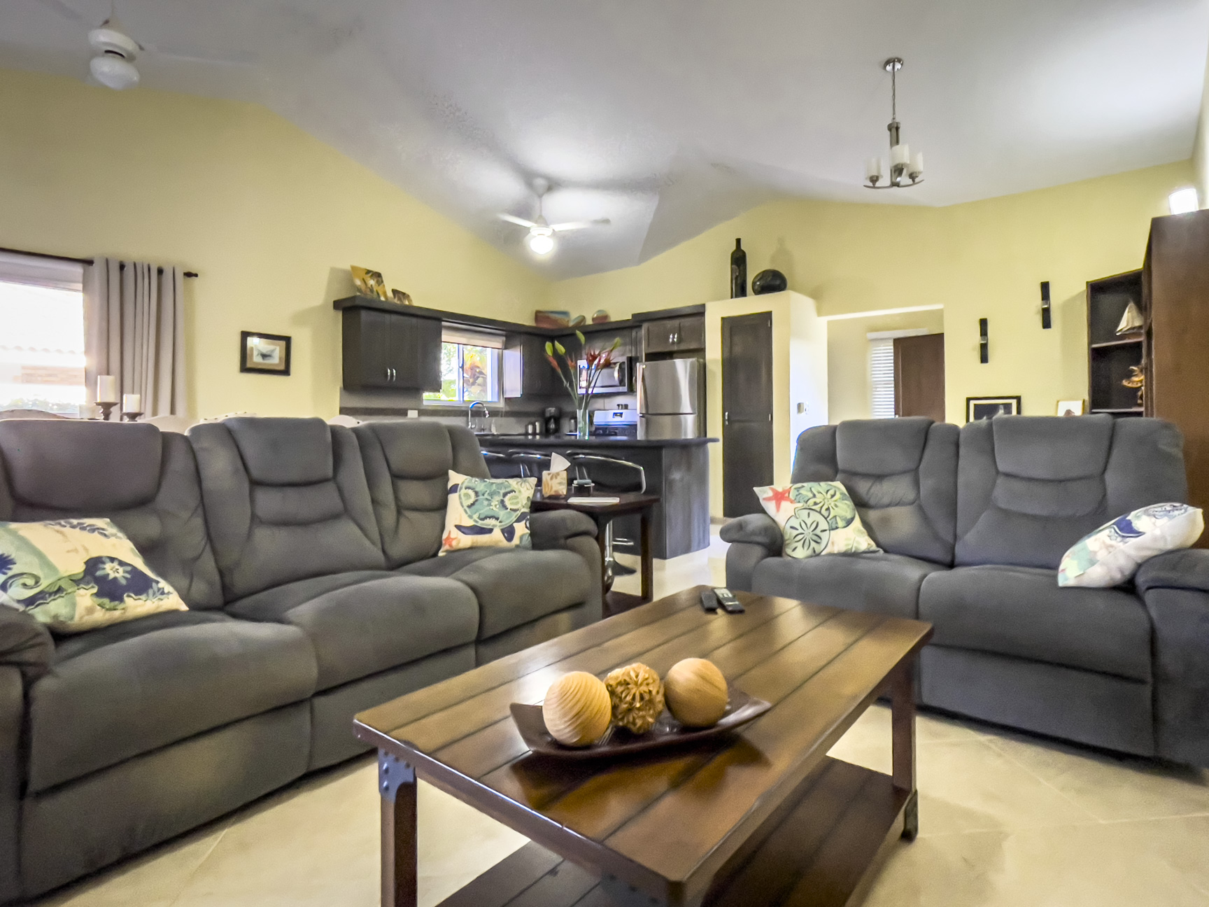 buyDRproperty Living room of a stunning 2 bedroom villa with gray sofas and a wooden coffee table. Sosua Real Estate