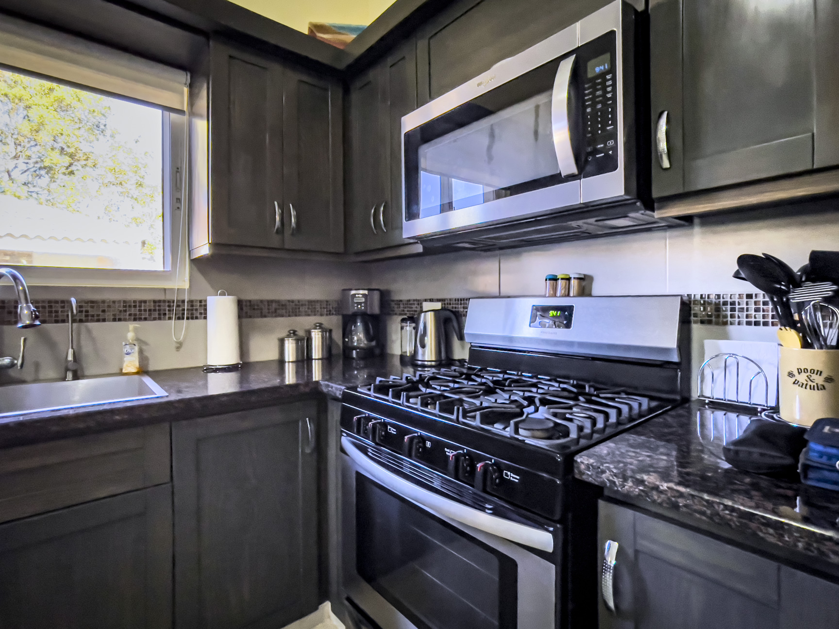 buyDRproperty Kitchen in a stunning 2 bedroom villa with dark cabinets and stainless steel appliances. Sosua Real Estate