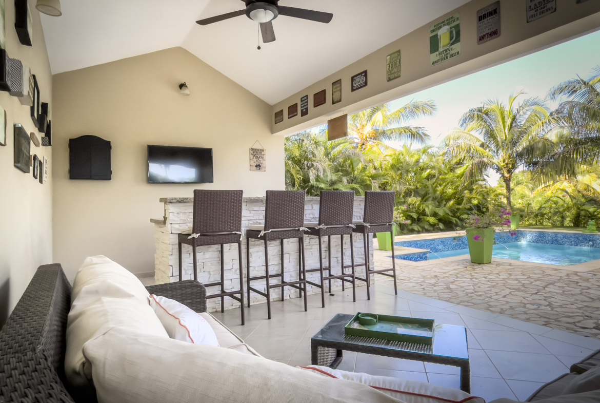 buyDRproperty Outdoor bar area with pool view at a stunning 2 bedroom villa Sosua Real Estate