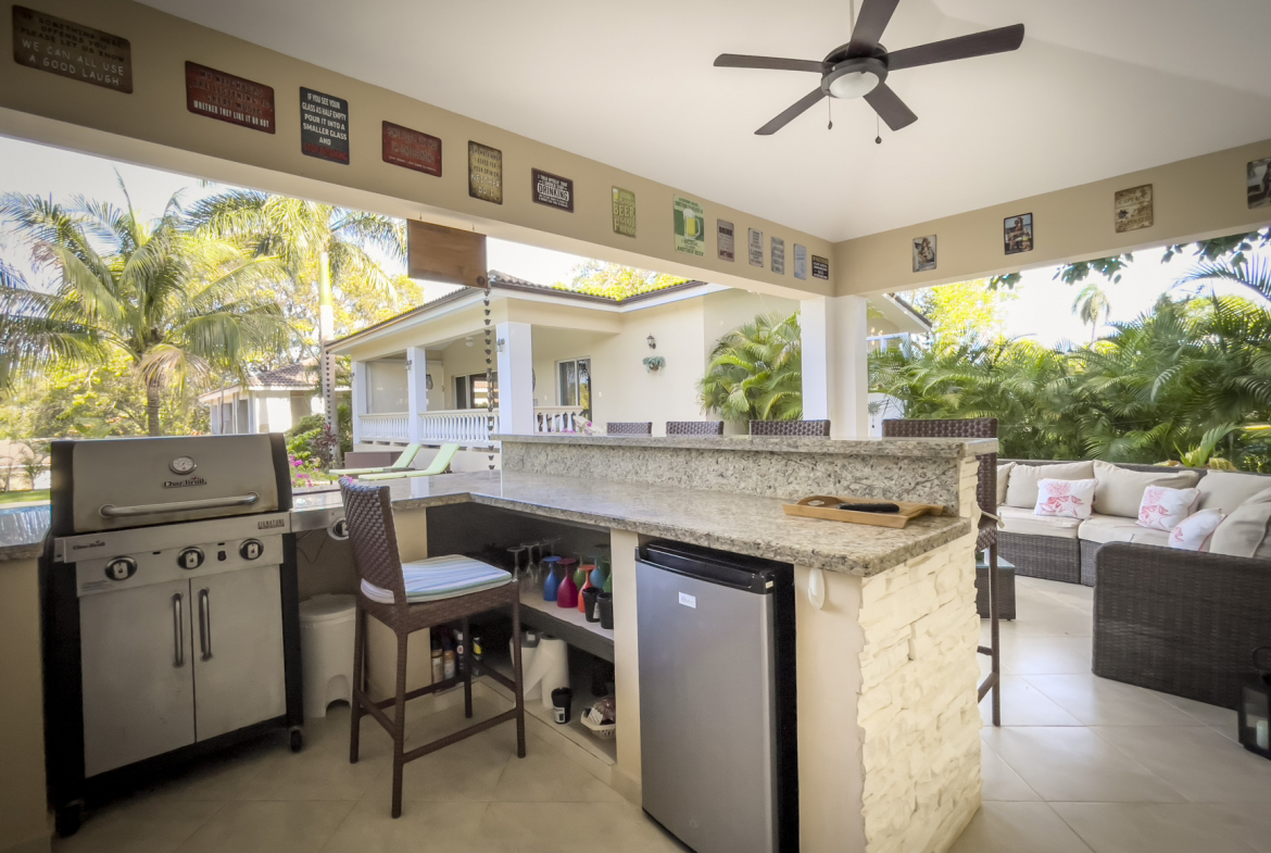 buyDRproperty Outdoor kitchen with a Char-Broil grill and bar, part of a stunning 2 bedroom villa. Sosua Real Estate
