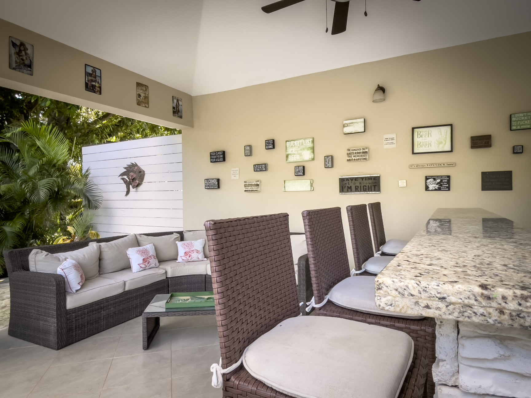 buyDRproperty Outdoor bar area with seating and decorative wall signs in a Stunning 2 Bedroom Villa Sosua Real Estate