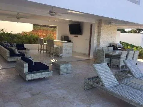 buyDRproperty Luxury 3BR Villa Seashell Casa Linda outdoor living area with lounge chairs Sosua Real Estate