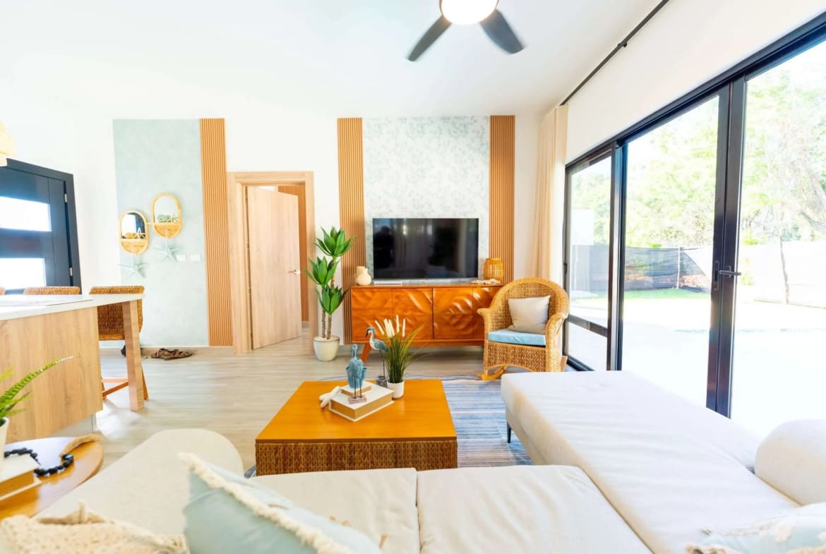 Villa Capri Casa Linda: Living room with ocean-inspired decor and large sliding doors
