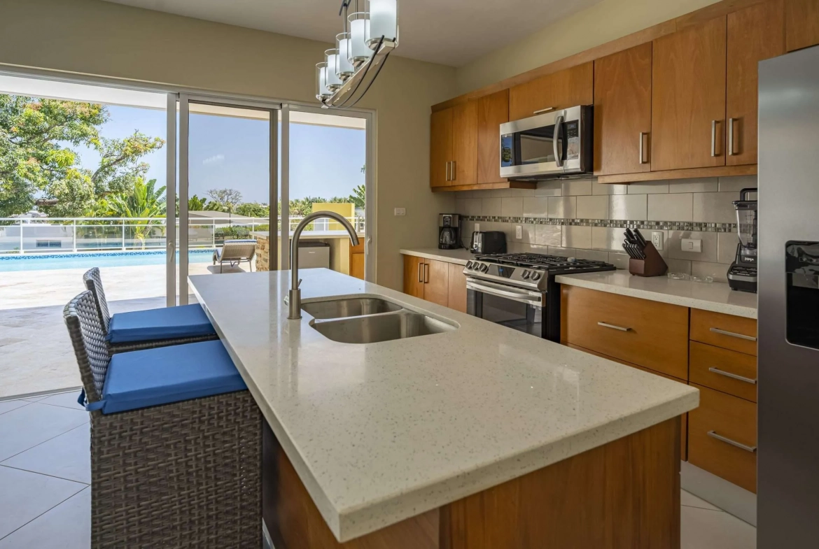 buyDRproperty Villa Seashell Casa Linda kitchen with island, pool view Sosua Real Estate