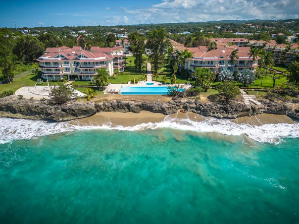 buyDRproperty Oceanfront condo in Sosua with a turquoise ocean and a swimming pool Sosua Real Estate