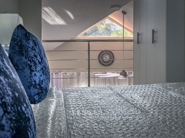buyDRproperty Modern 1-bedroom condo bedroom with loft, blue velvet pillows on bed. Sosua Real Estate