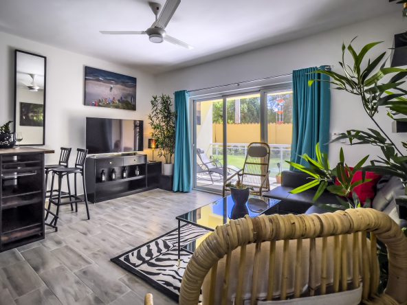 buyDRproperty Stylish one bedroom condo living room with modern furniture and a view Sosua Real Estate