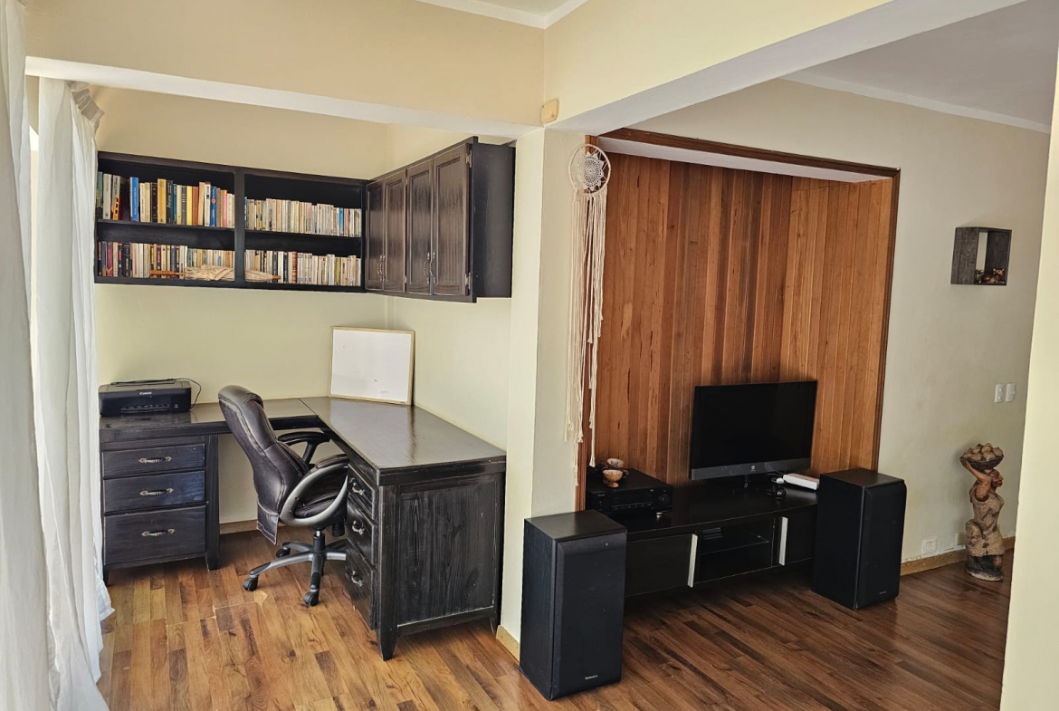 buyDRproperty Home office and living room in a spacious Sosua villa. Unique built-in desk and shelving. Sosua Real Estate