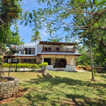 Buydrproperty Spacious Villa with a Large Lawn and Trees Showcasing Its Unique Architecture and Beautiful Views Sosua Real Estate Buydrpropertycom Buydrpropertycom