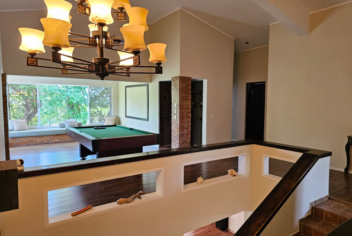 buyDRproperty Spacious Sosua villa with a pool table and large windows offering beautiful views. Sosua Real Estate