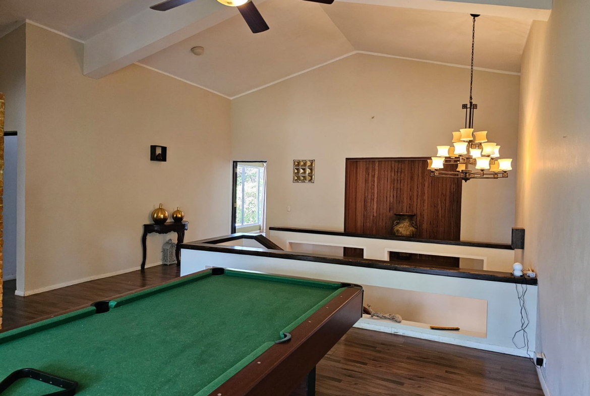 buyDRproperty Spacious villa interior with pool table and unique architectural features. Sosua Real Estate