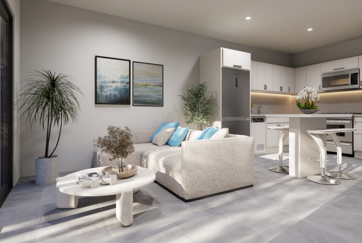 buyDRproperty Stylish townhouse living room with sectional sofa and modern kitchen Sosua Real Estate