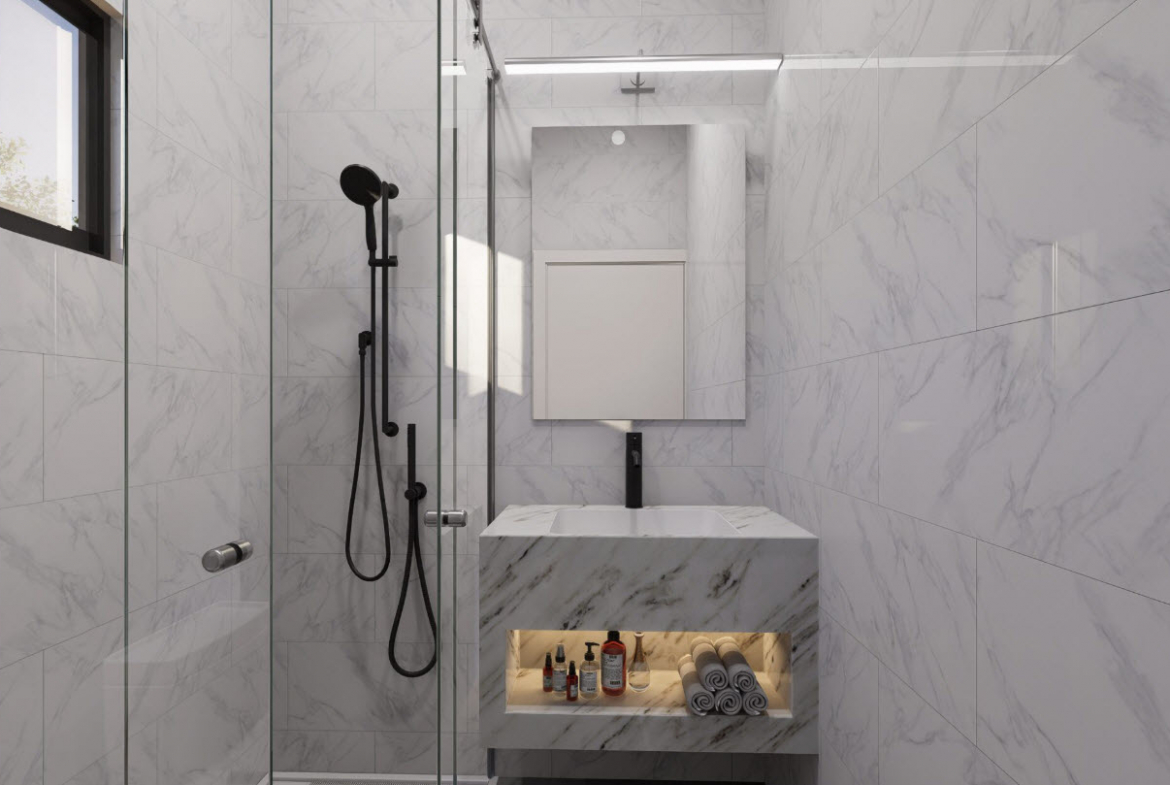 buyDRproperty Modern bathroom with marble tiles, black shower, and townhouse vanity with toiletries. Sosua Real Estate