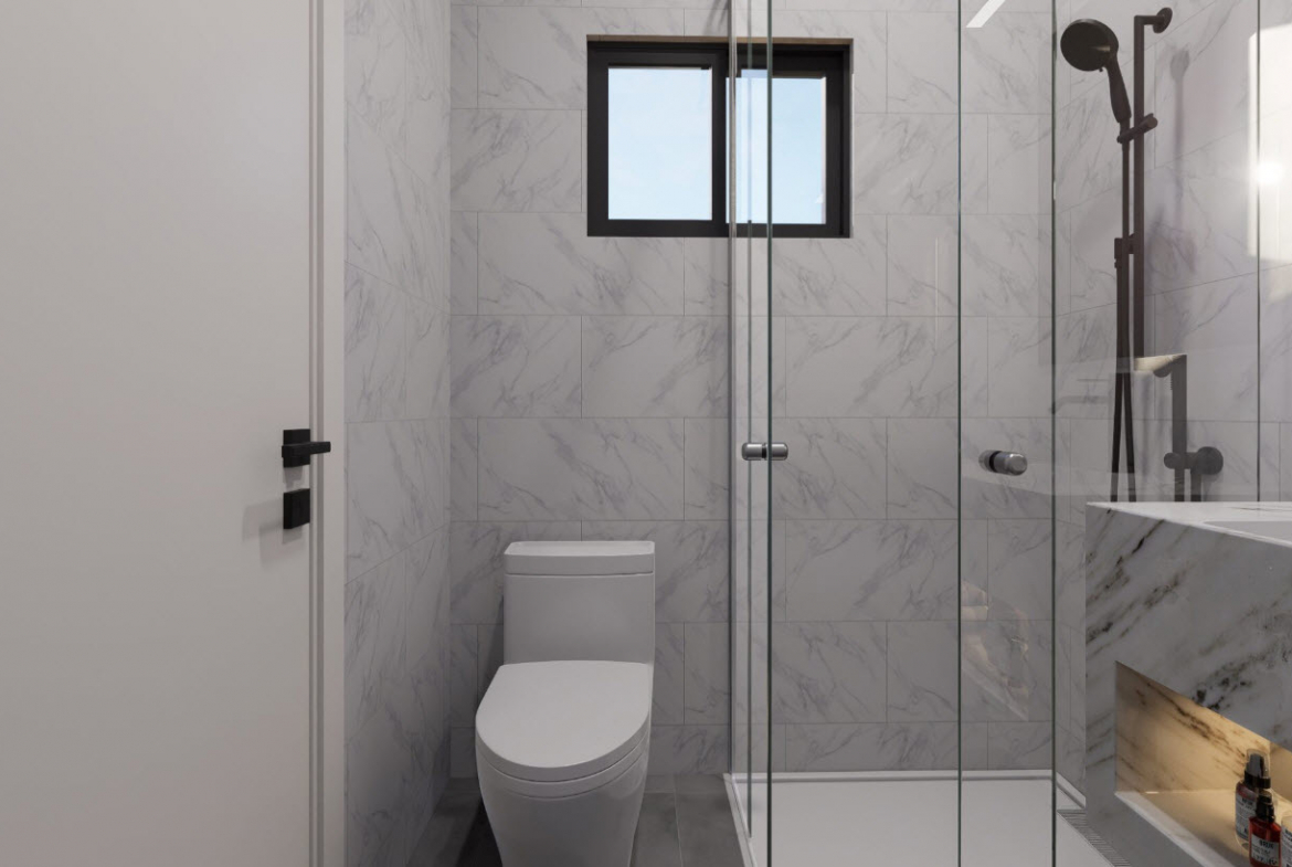 buyDRproperty Modern bathroom in a Casa Linda townhouse with glass shower and marble-look tiles. Sosua Real Estate