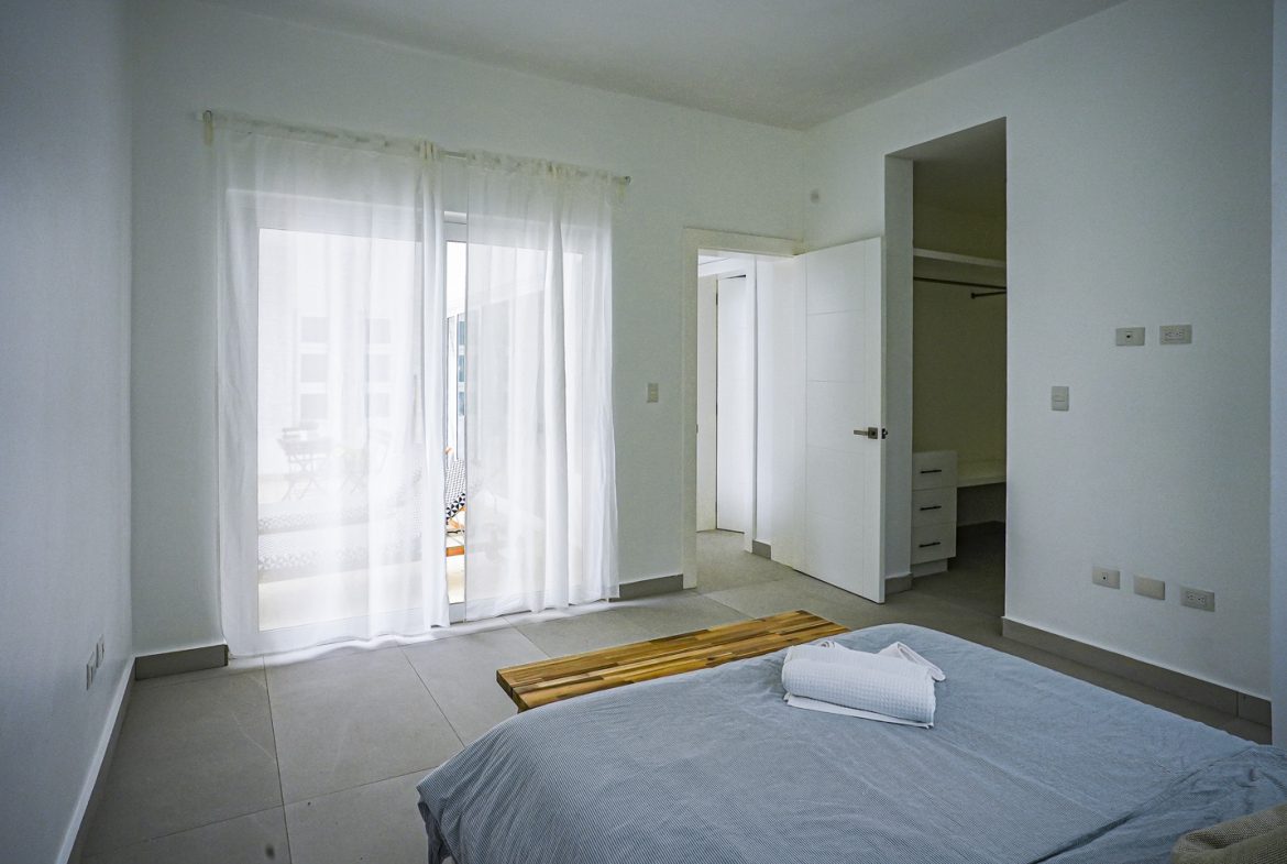 buyDRproperty Modern bedroom with sheer curtains and a view of a balcony. Sosua Real Estate
