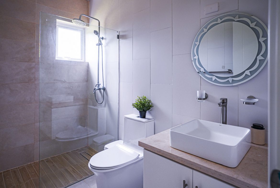 buyDRproperty Modern bathroom in a villa featuring a shower, toilet, and sink. Sosua Real Estate