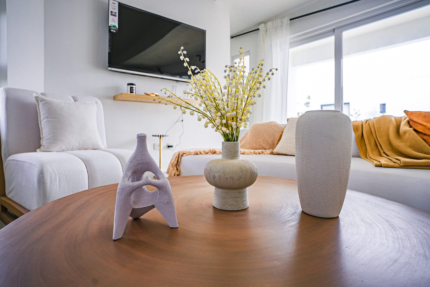buyDRproperty Modern living room decor with vases on a wooden coffee table. Sosua Real Estate
