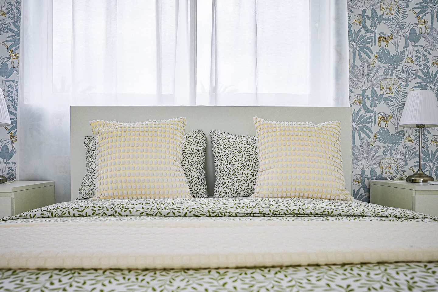 buyDRproperty Modern bedroom with patterned pillows and wallpaper Sosua Real Estate