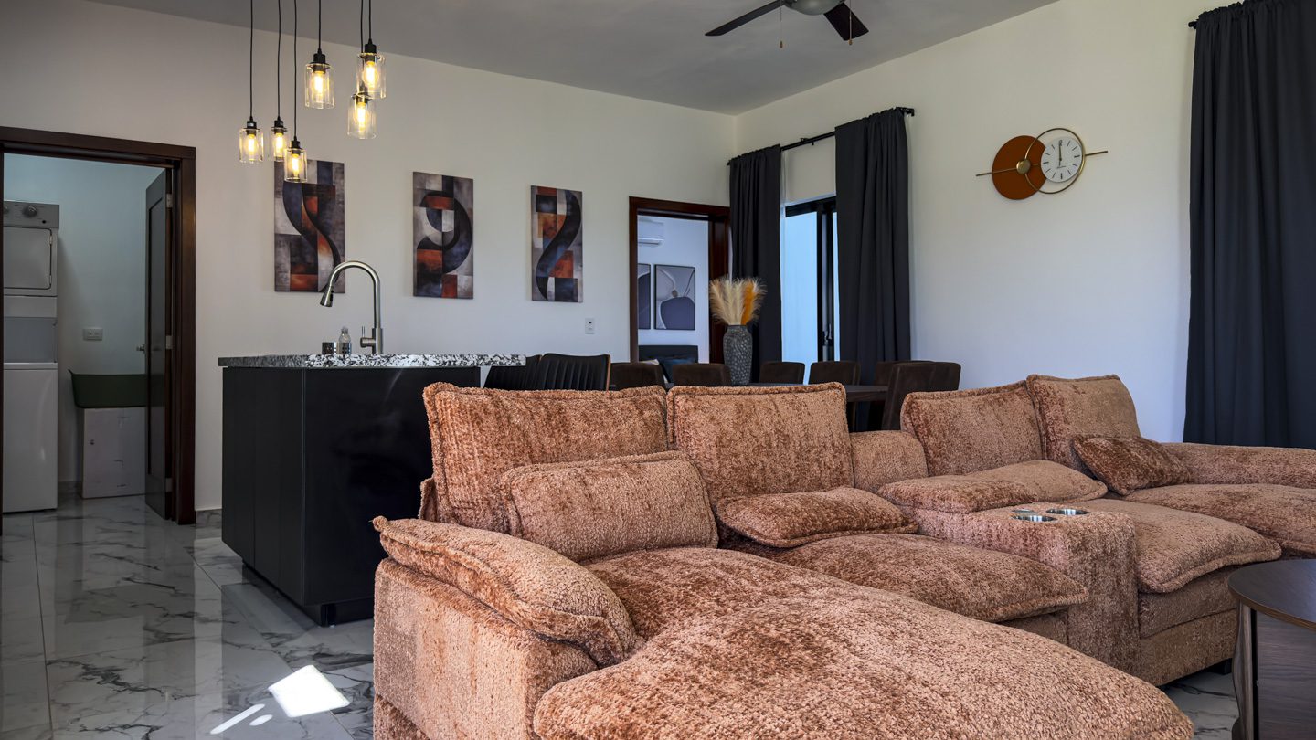 buyDRproperty Modern living room in a 3BR Villa Sosua Ocean Village with stylish decor and comfortable seating. Sosua Real Estate