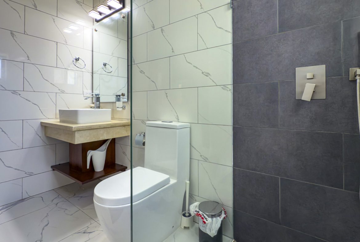 buyDRproperty Modern bathroom with marble tile, floating vanity, and walk-in shower. Sosua Real Estate