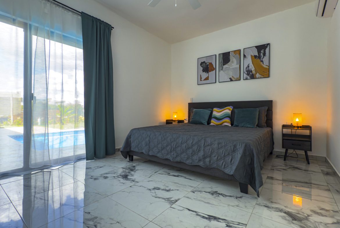 buyDRproperty Modern bedroom with a king-size bed in a Sosua Villa. Sosua Real Estate