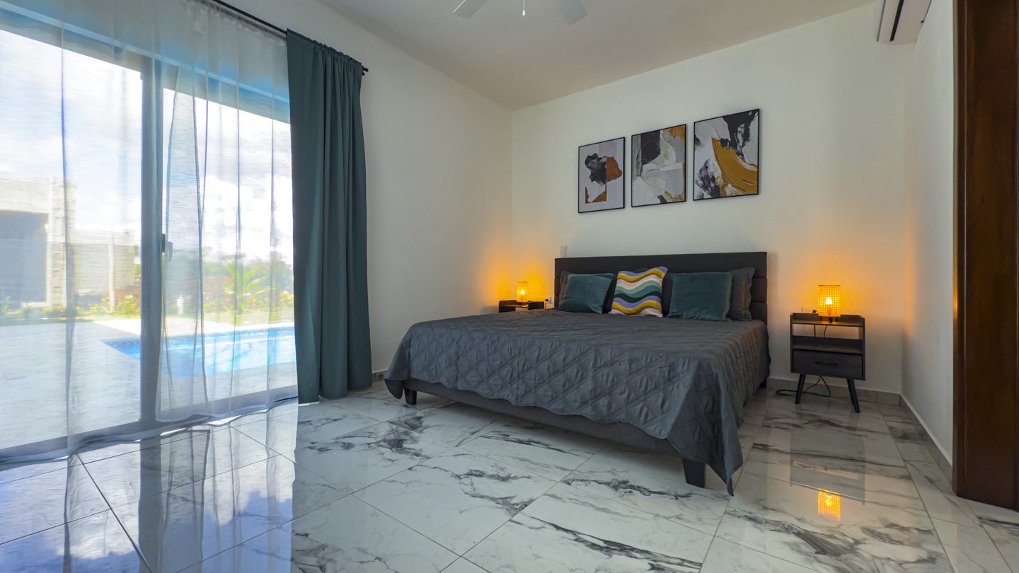 buyDRproperty Modern bedroom with a king-size bed in a Sosua Villa. Sosua Real Estate