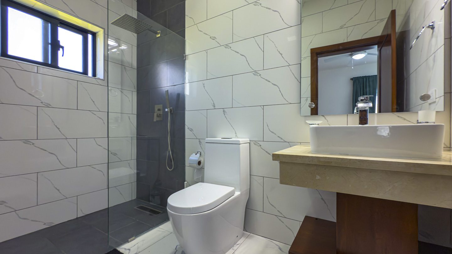 buyDRproperty Modern bathroom in a villa in Sosua Ocean Village with a walk-in shower and toilet Sosua Real Estate