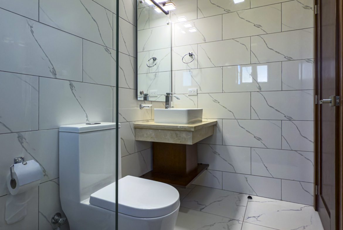 buyDRproperty Modern bathroom with marble tile, square sink, and toilet Sosua Real Estate