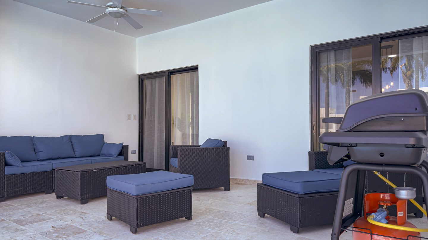 buyDRproperty Outdoor patio with modern furniture and grill at a villa in Sosua Ocean Village. Sosua Real Estate