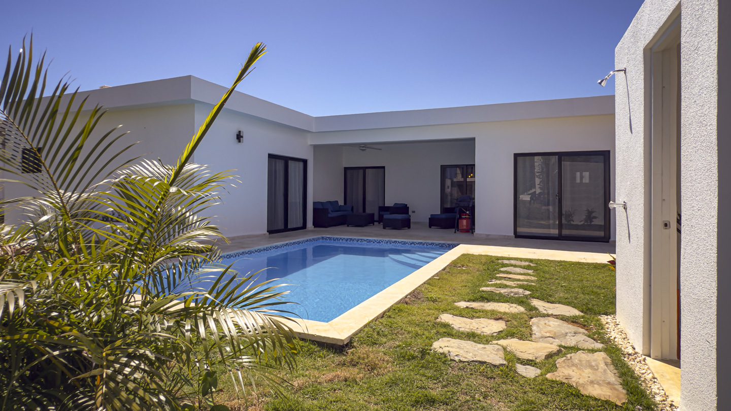 buyDRproperty Modern villa with a pool and outdoor seating in Sosua Ocean Village. Sosua Real Estate