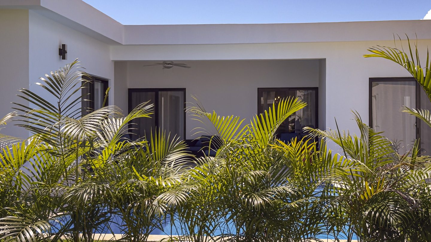 buyDRproperty Modern 3BR Villa in Sosua Ocean Village with palm trees and a pool Sosua Real Estate