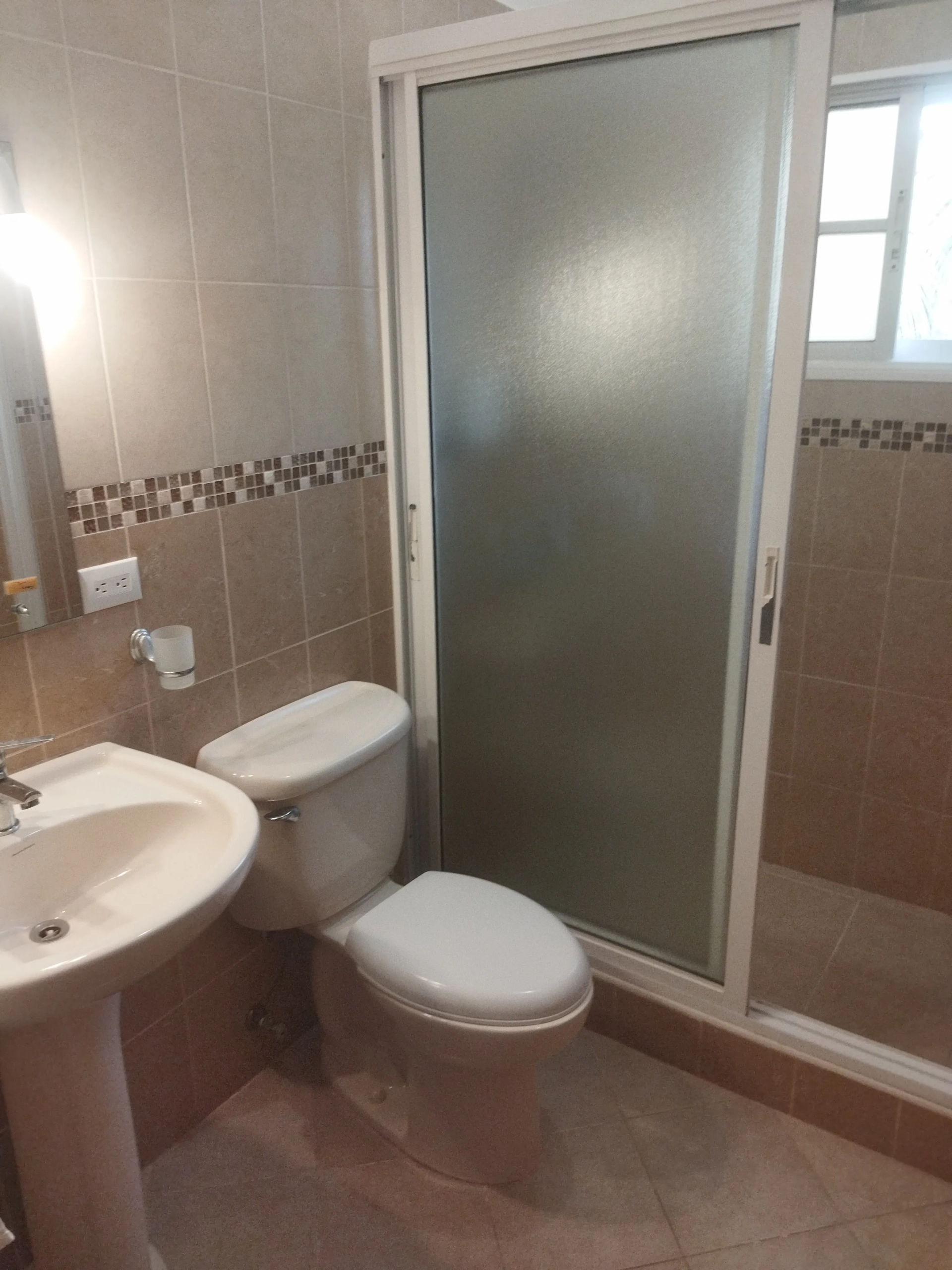 buyDRproperty Charming bathroom with toilet, sink, and shower. Sosua Real Estate