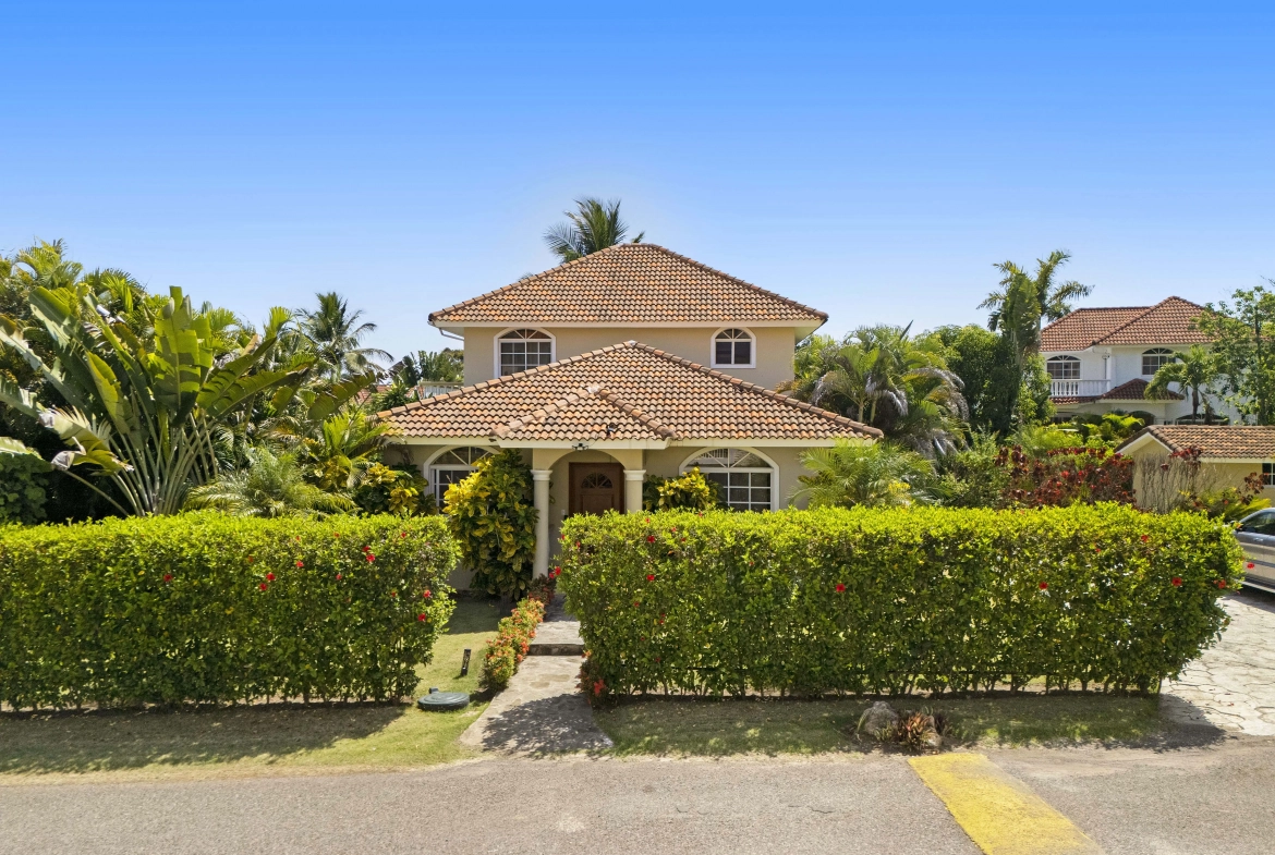 buyDRproperty Beautiful villa in Hispaniola Residencial with tile roof and lush landscaping. Sosua Real Estate
