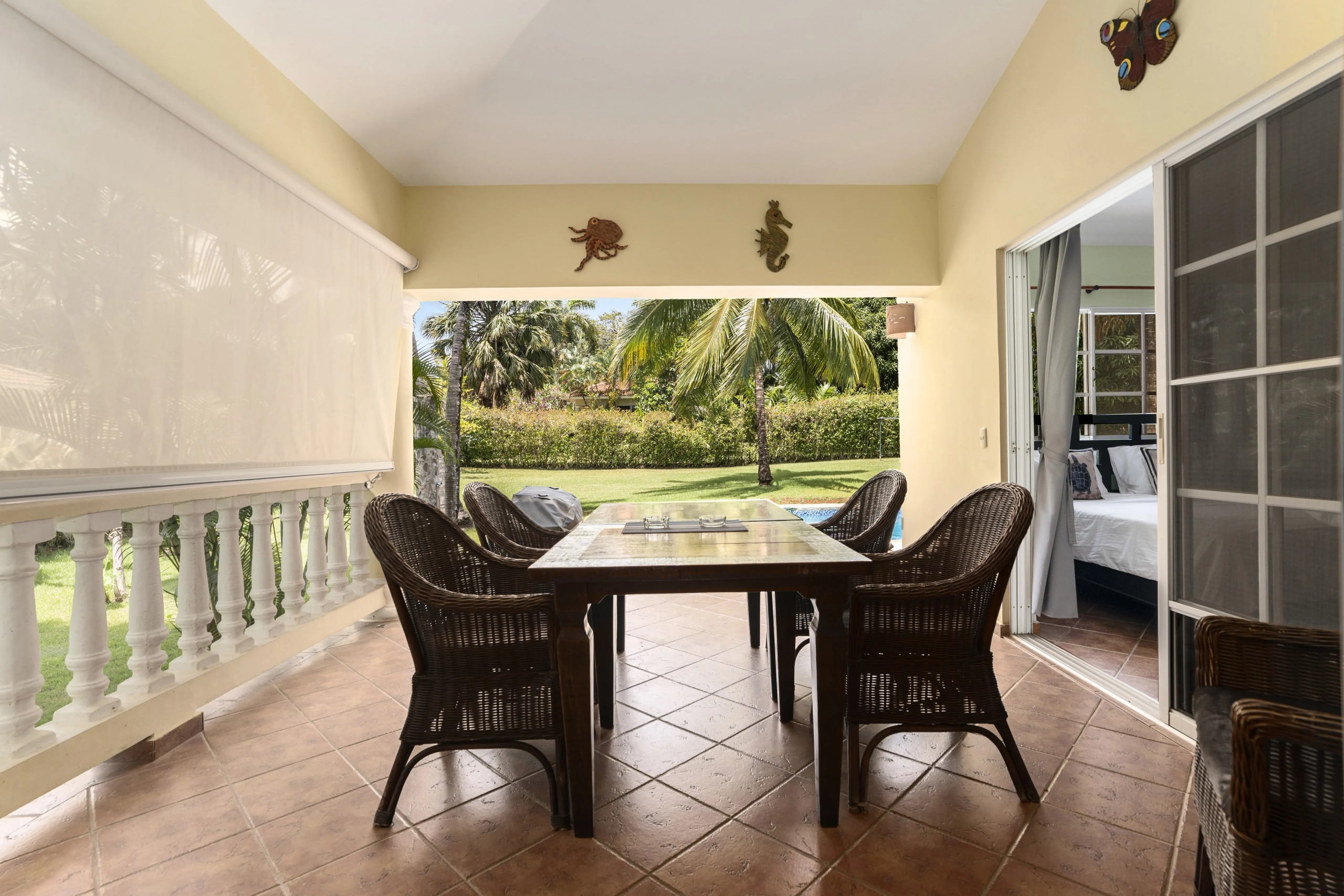 buyDRproperty Outdoor dining area with table and chairs, offering a view of the backyard. Sosua Real Estate