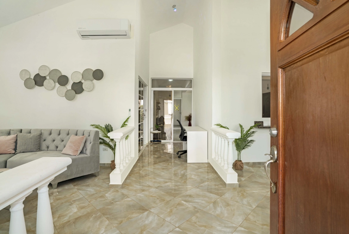 buyDRproperty Beautiful home interior with open door and hallway Sosua Real Estate