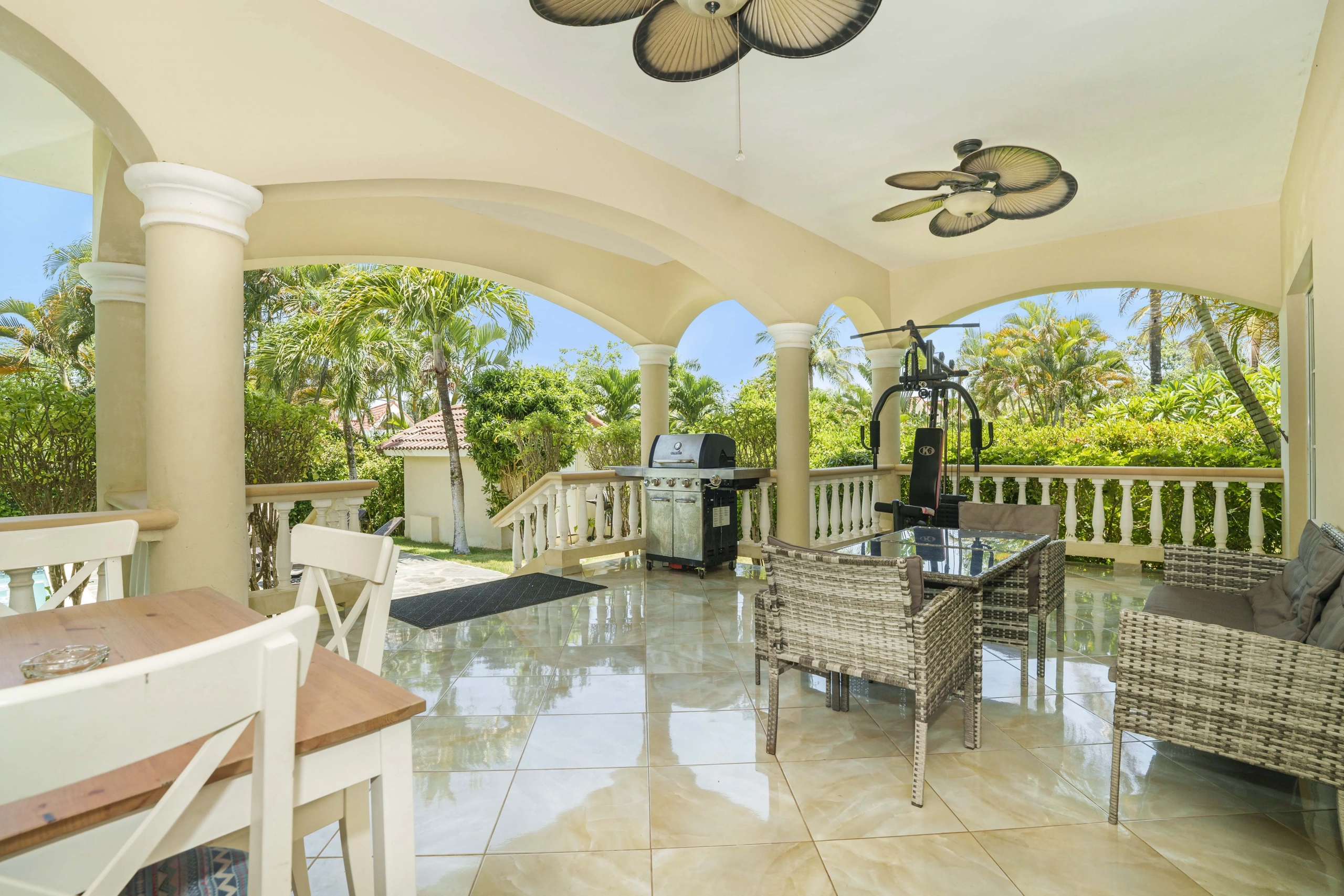buyDRproperty Beautiful outdoor patio with seating, grill, and exercise equipment. Sosua Real Estate