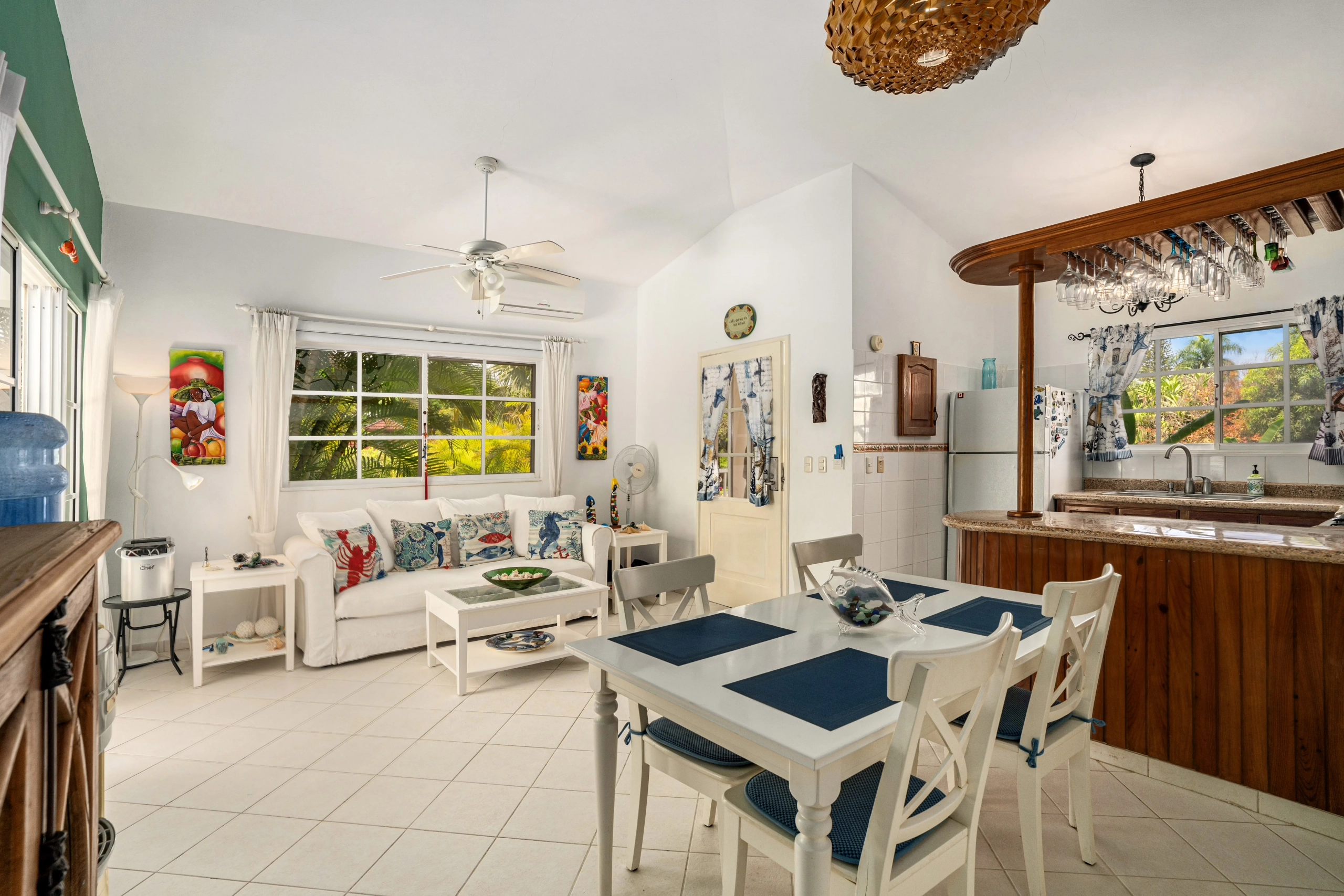 buyDRproperty Charming living and dining area in a Sosua villa with white furniture and colorful accents. Sosua Real Estate