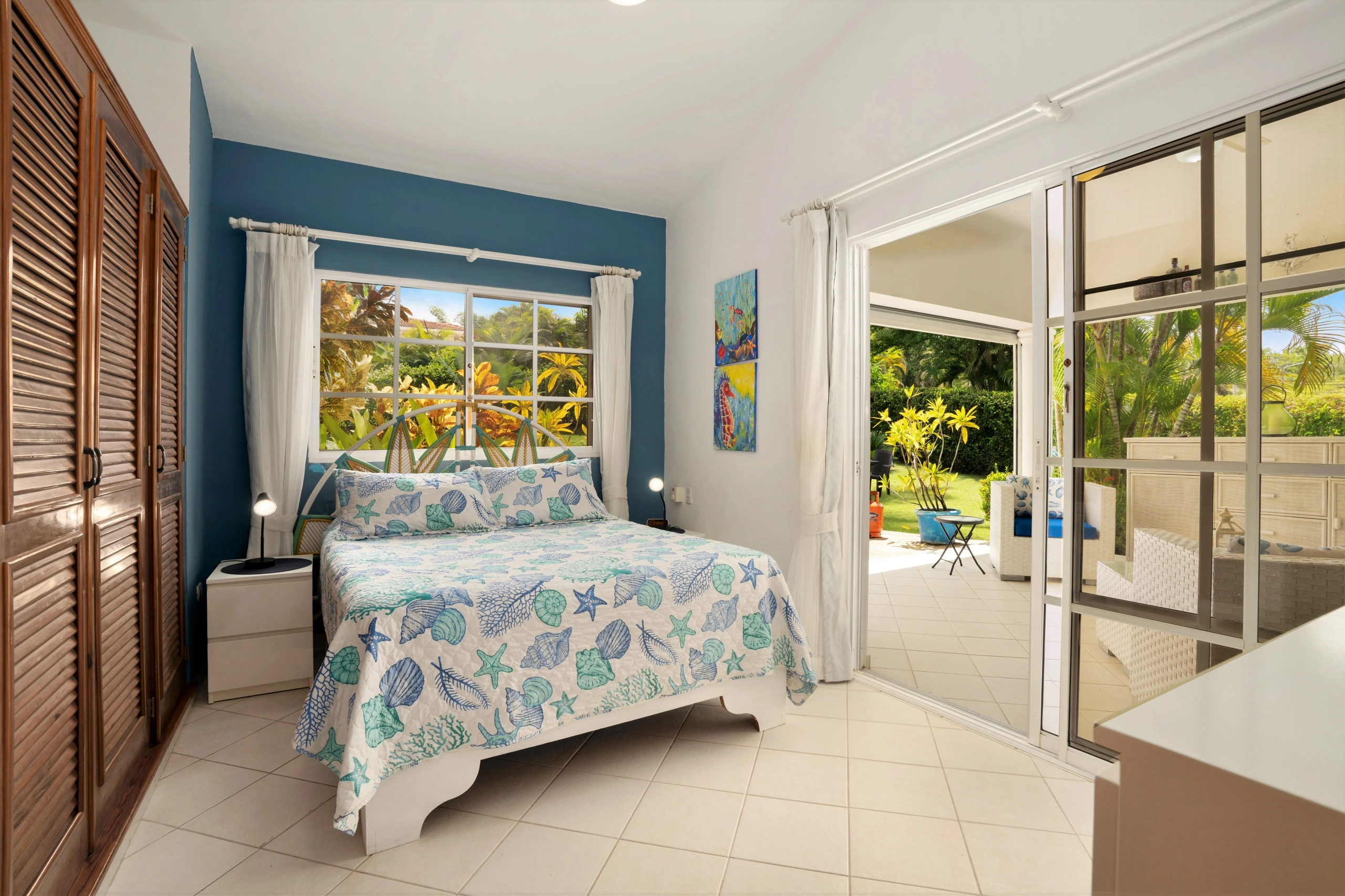 buyDRproperty Charming bedroom with sea-themed bedding and patio access Sosua Real Estate