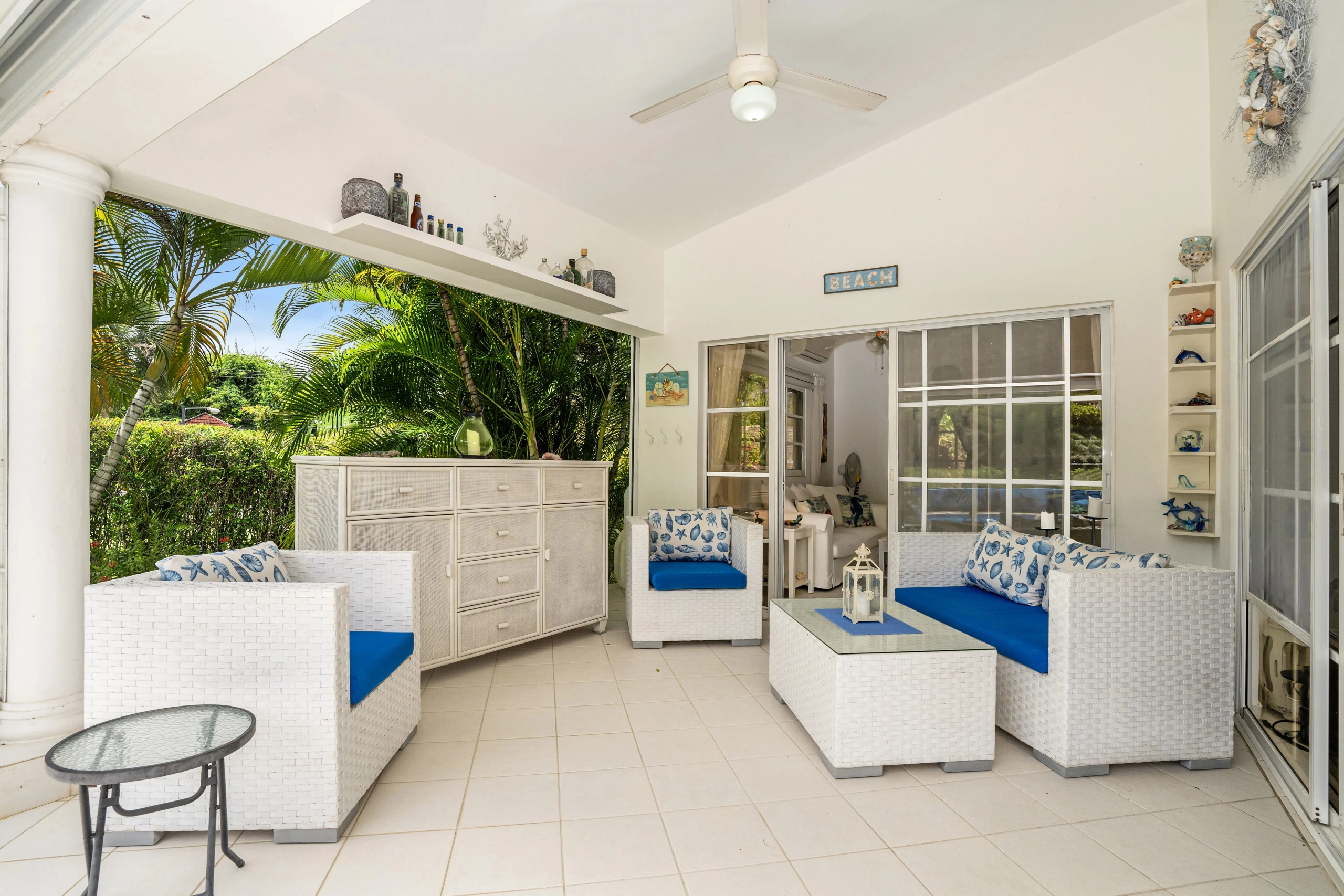 buyDRproperty Charming outdoor living space with white wicker furniture and blue cushions. Sosua Real Estate
