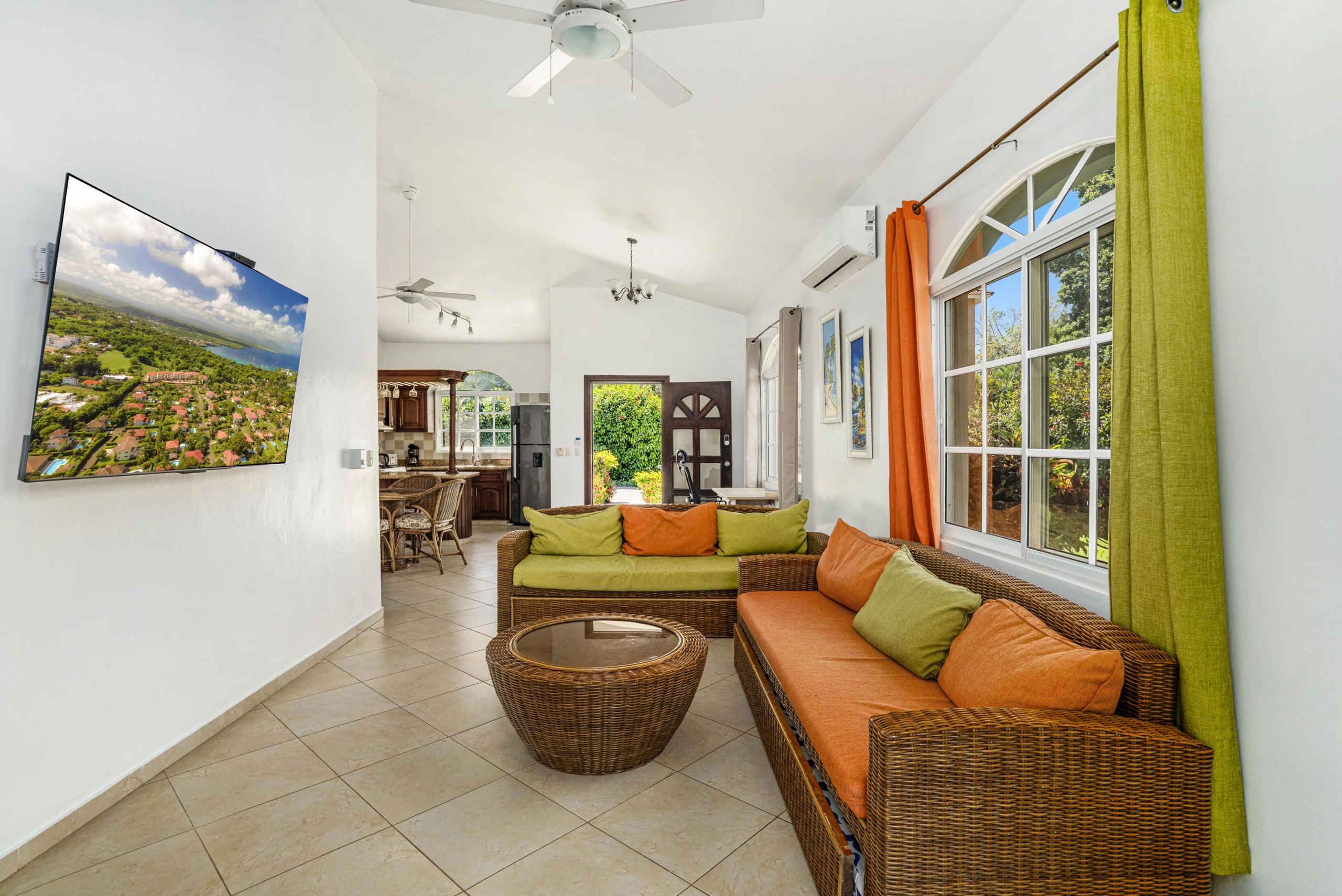 buyDRproperty Spacious, oversized villa living room with wicker furniture and colorful cushions. Sosua Real Estate