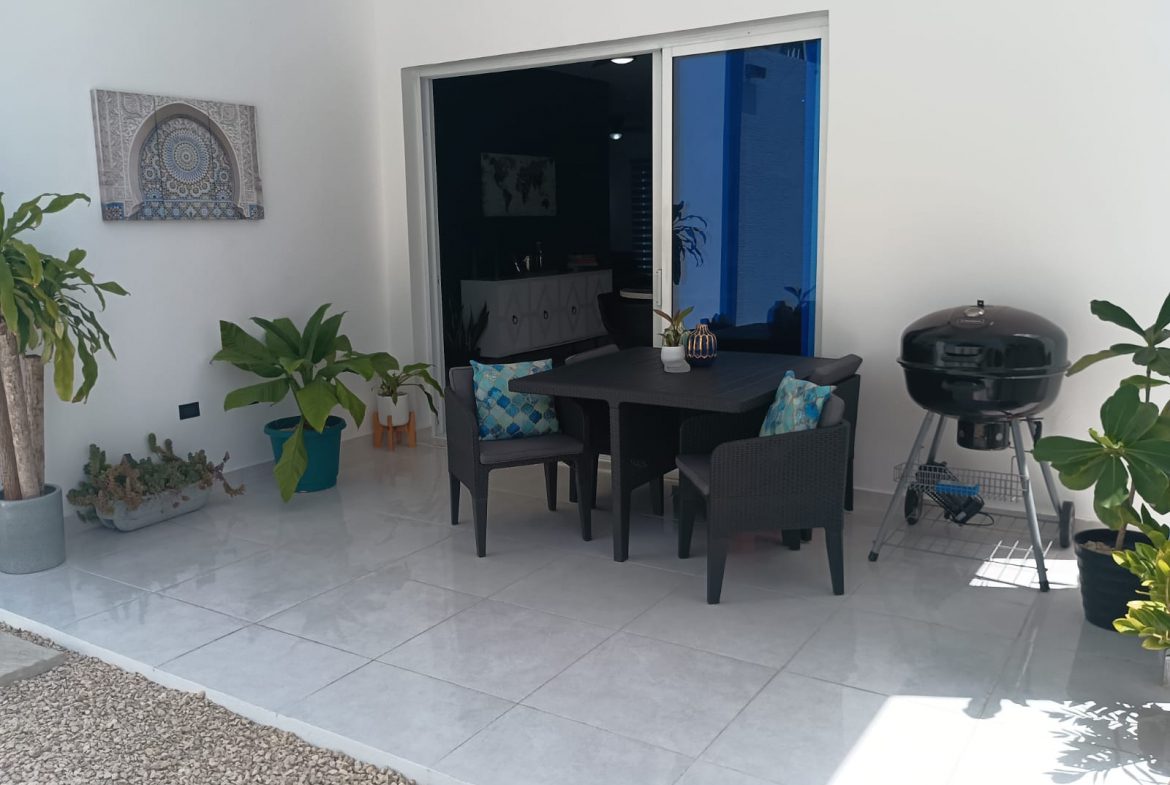 buyDRproperty Modern outdoor patio with table, chairs, and grill at a villa. Sosua Real Estate