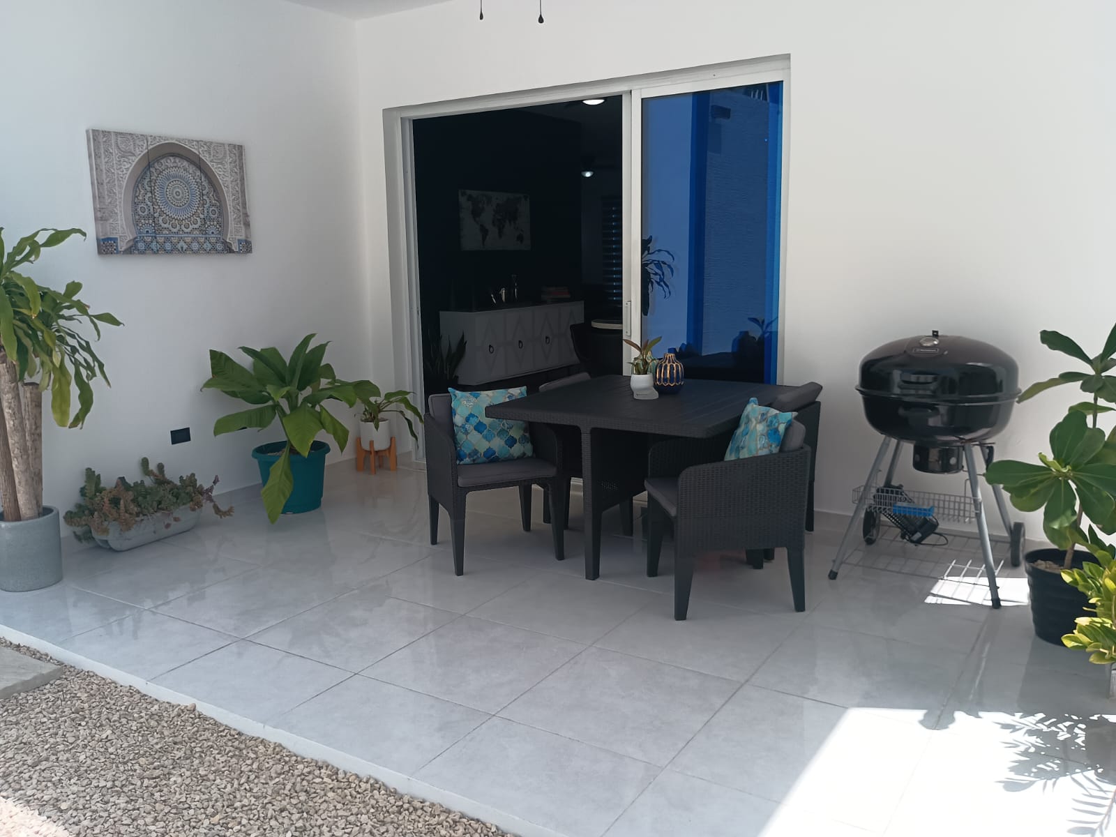buyDRproperty Modern outdoor patio with table, chairs, and grill at a villa. Sosua Real Estate