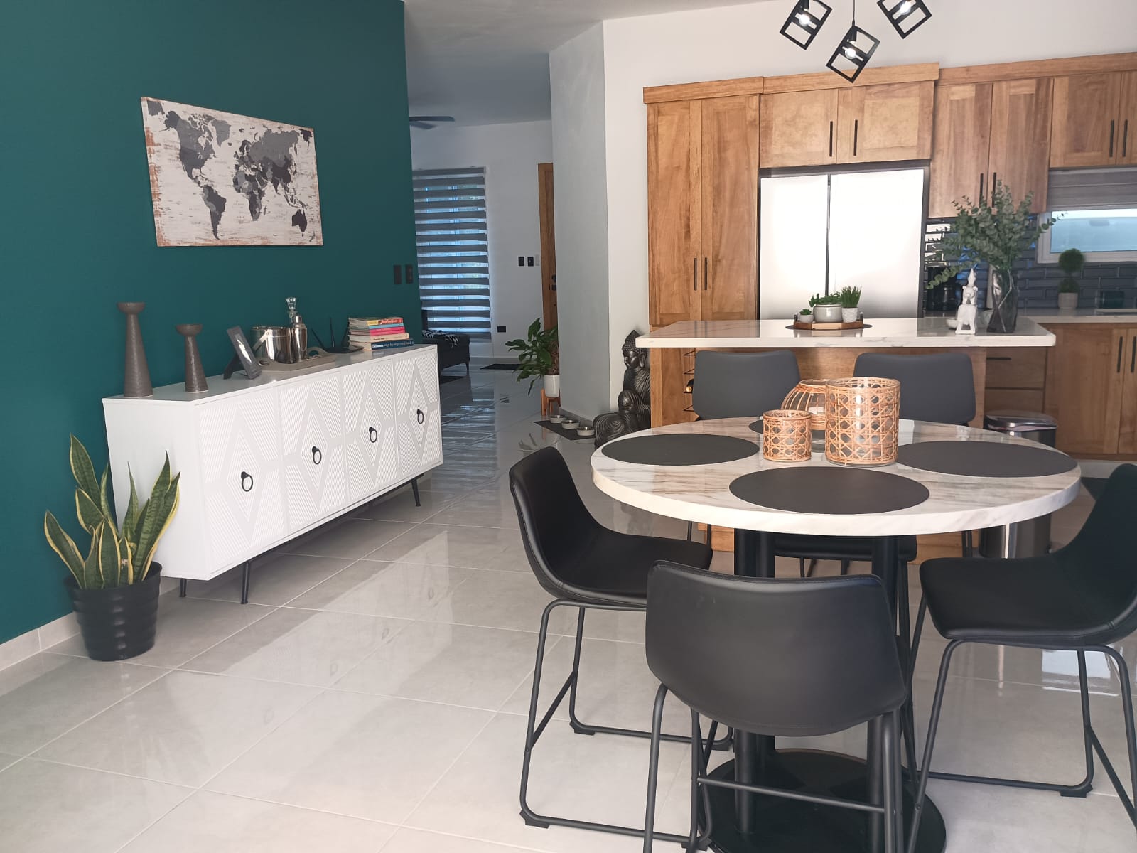 buyDRproperty Modern dining room with round table and black chairs in a Puerto Plata villa. Sosua Real Estate