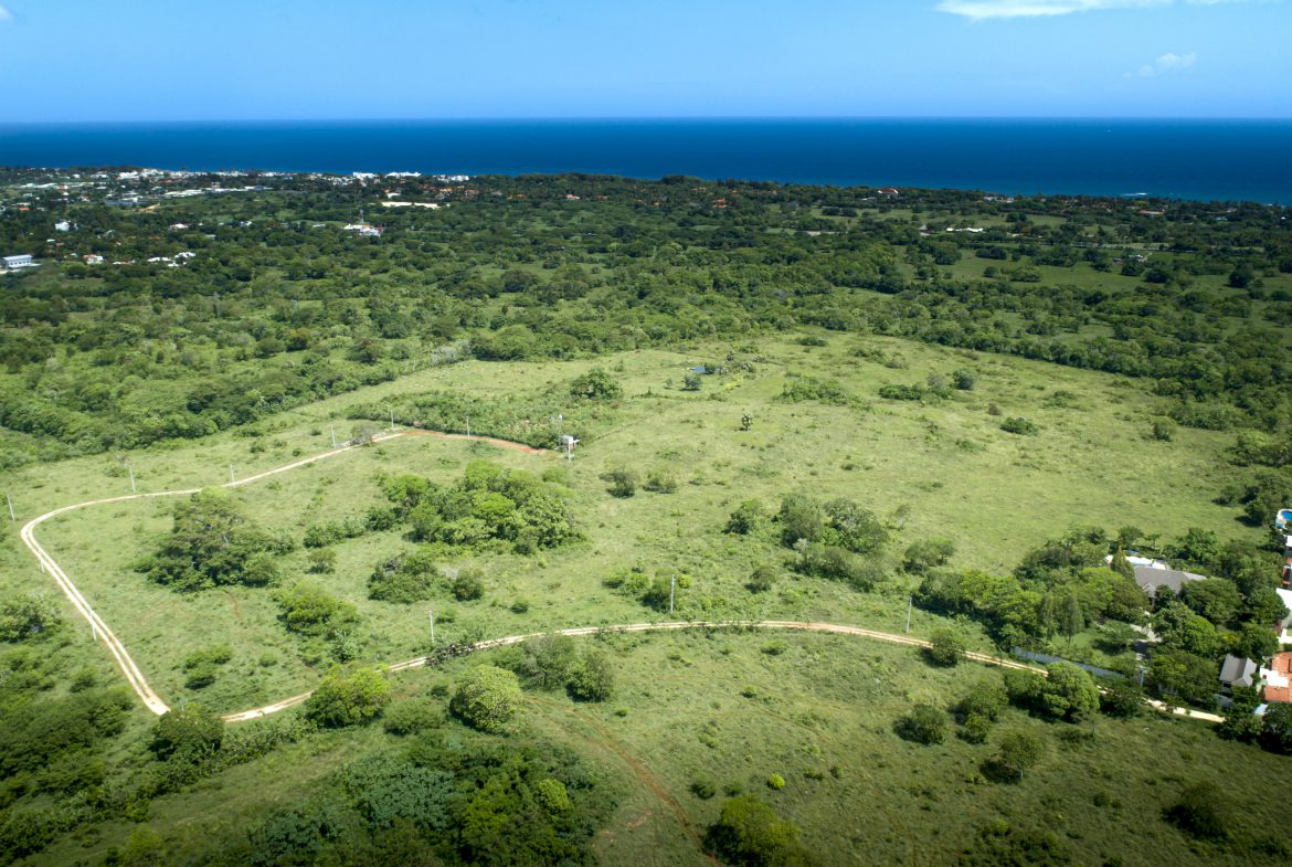 buyDRproperty Countryside building lot overview between Sosúa & Cabarete, Dominican Republic. Lush green landscape meets the ocean. Sosua Real Estate