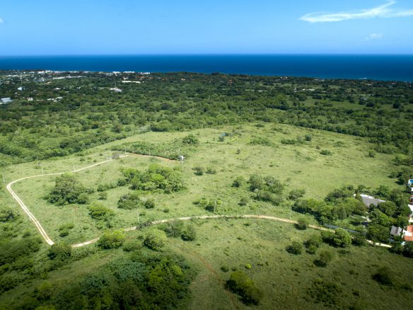 buyDRproperty Countryside building lot overview between Sosúa & Cabarete, Dominican Republic. Lush green landscape meets the ocean. Sosua Real Estate