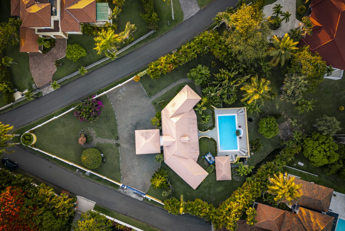 buyDRproperty Aerial view of a luxury villa with a pool, showcasing its lush landscaping and prime location. Ocean Views. Sosua Real Estate