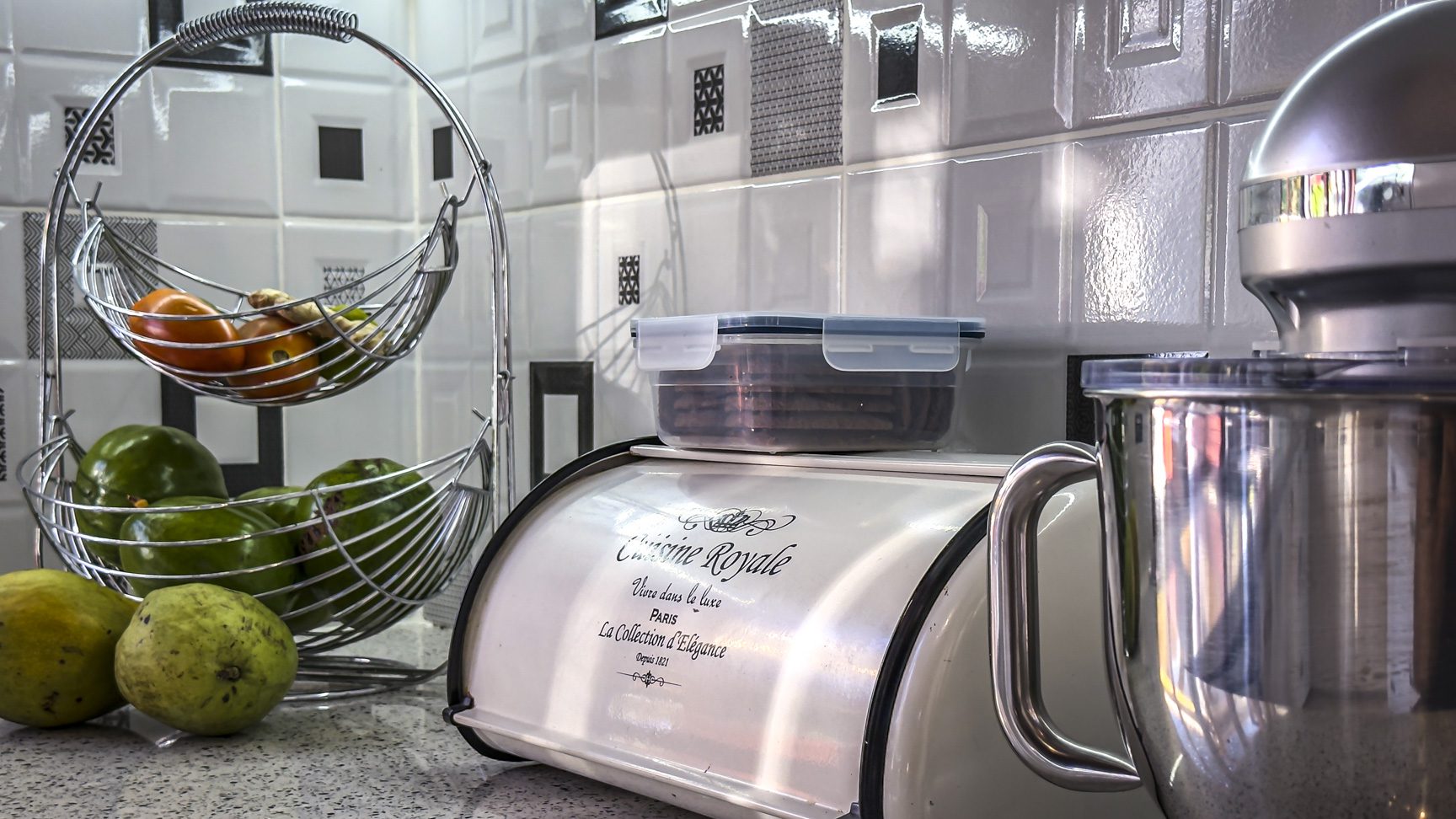 buyDRproperty Kitchen counter with fruit basket, bread box, and mixer, showcasing villa interior design. Sosua Real Estate