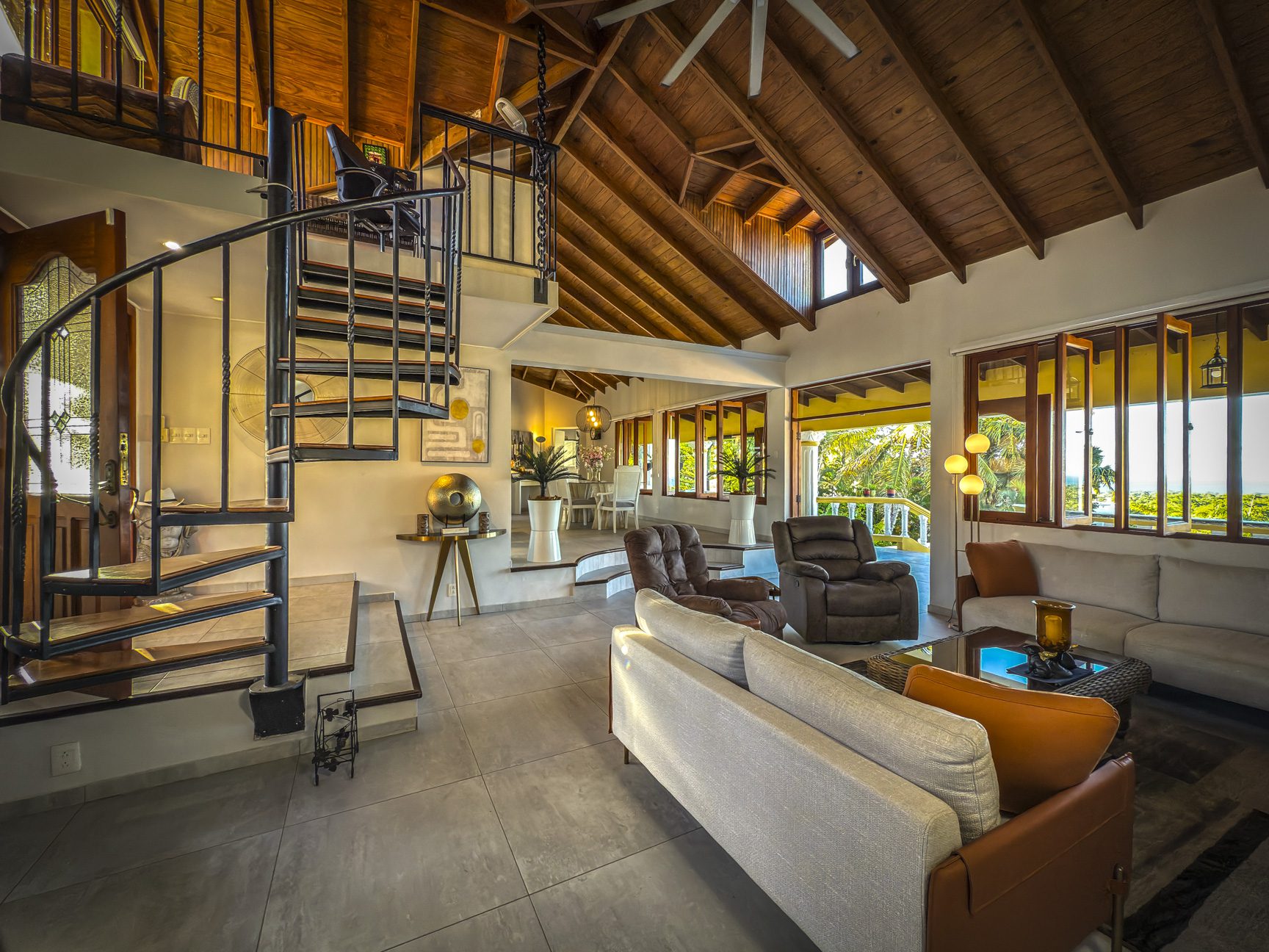 buyDRproperty Luxury villa interior with spiral staircase and ocean views. Villa for sale in Panorama Village. Sosua Real Estate
