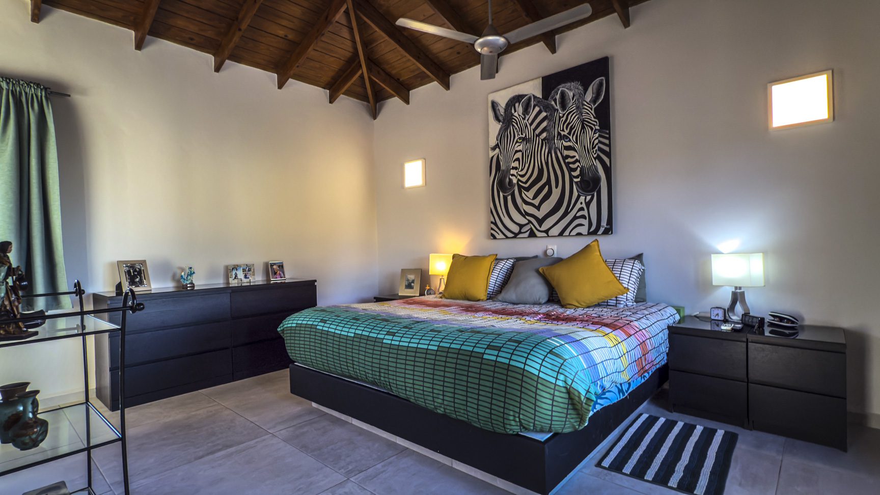 buyDRproperty Bedroom in a luxury villa with zebra artwork, featuring ocean views. Villa for sale in Panorama Village. Sosua Real Estate